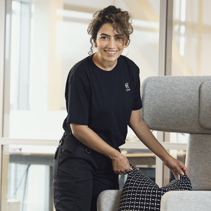  Woman putting a pillow on a chair and smiling |Coor 